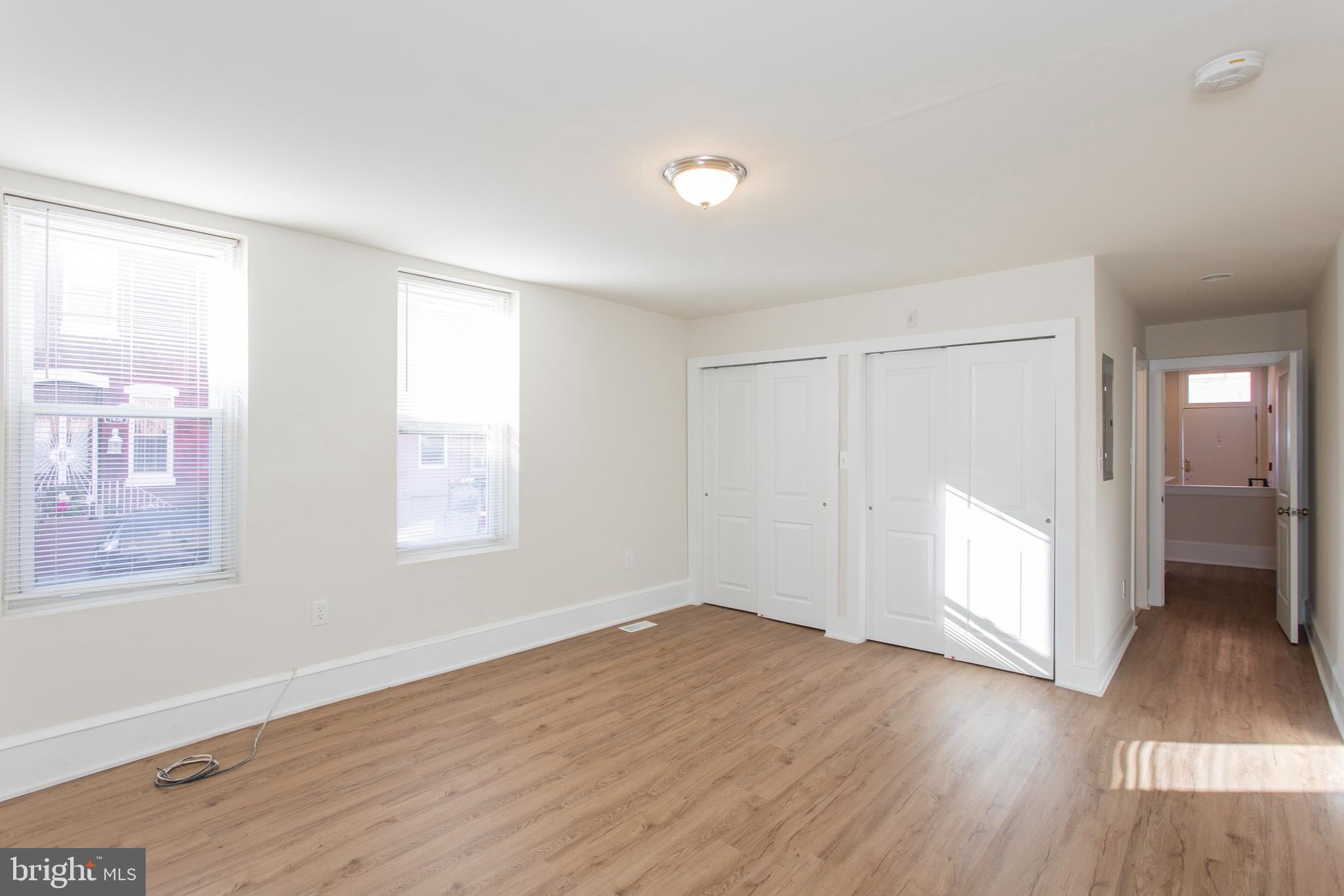 767 South 15th Street Philadelphia, PA 19146 - Photo 8 of 69 an empty room with wooden floor and windows
