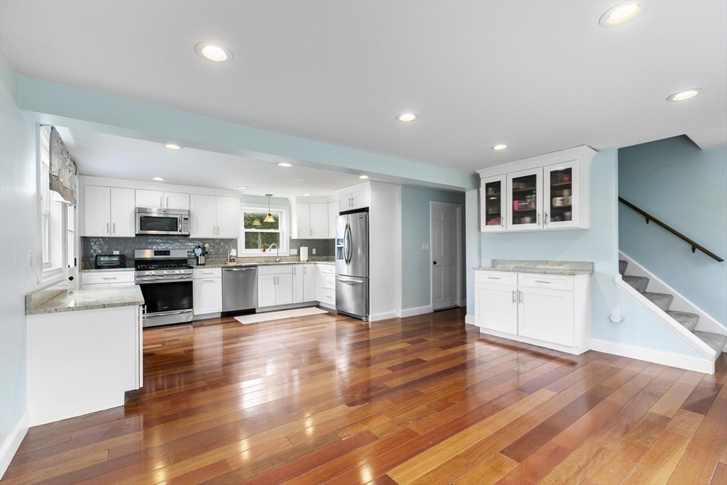49 Baldwin Road Billerica, MA 01821 - Photo 6 of 42 a kitchen with a refrigerator and a stove top oven