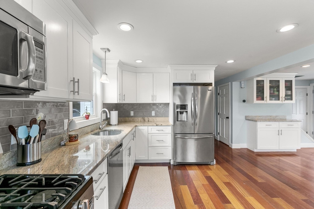 49 Baldwin Road Billerica, MA 01821 - Photo 8 of 42 a kitchen with a refrigerator and a stove top oven