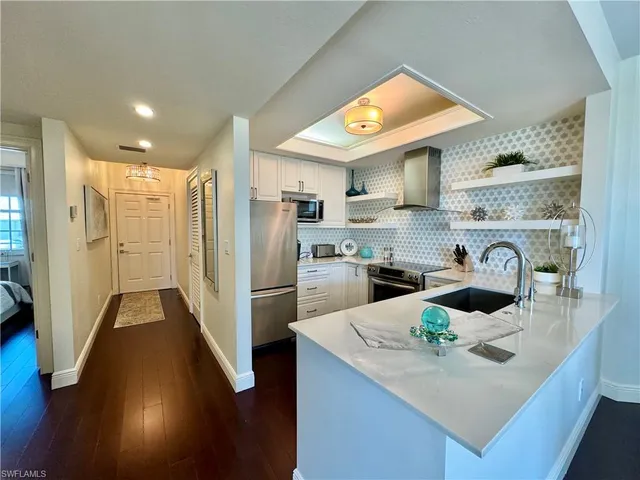 a kitchen with refrigerator cabinets and wooden floor