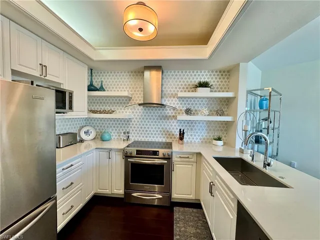 a kitchen with a sink a stove and cabinets