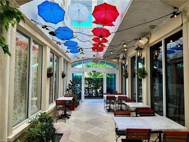 a room with lots of furniture and a potted plant