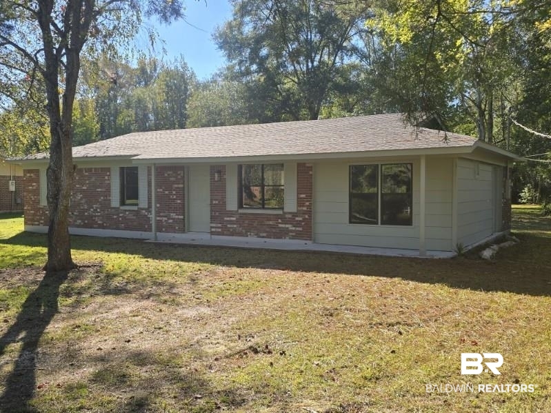 1404 Dailey Street Brewton, AL 36426 - Photo 2 of 25 Ranch-style home featuring a front yard, brick siding, and roof with shingles