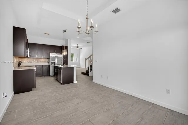 a kitchen with stainless steel appliances a refrigerator sink and microwave