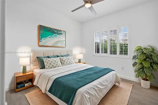 a bedroom with a bed and a potted plant