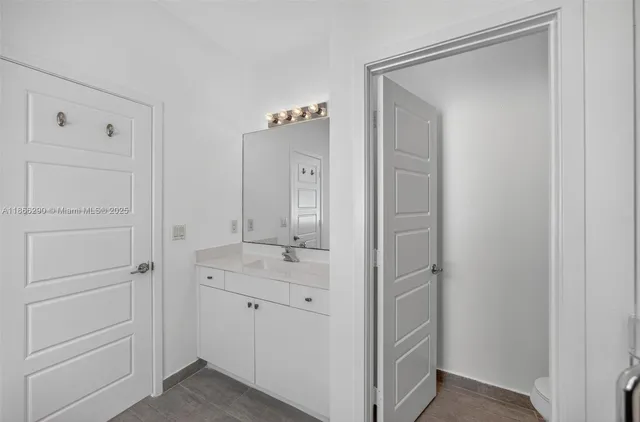 a bathroom with a shower sink and mirror