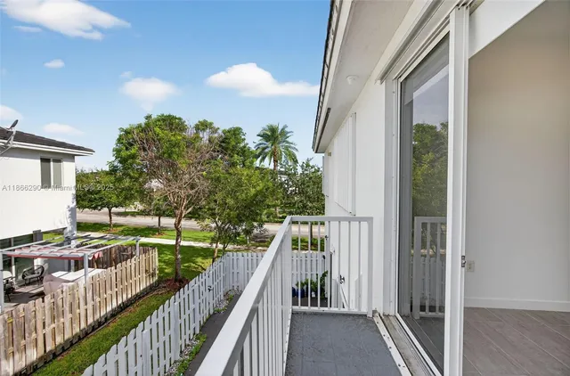 a view of balcony and yard