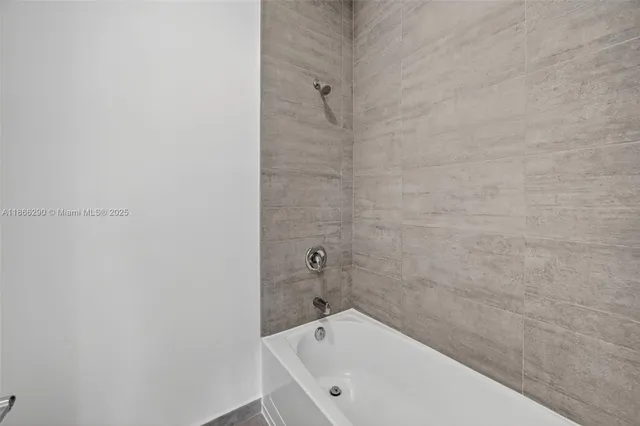 a bathroom with a bathtub and shower