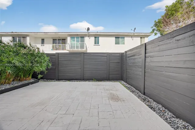 a view of a house with a wooden fence