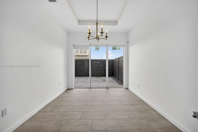 a view of a kitchen with a sink and a chandelier
