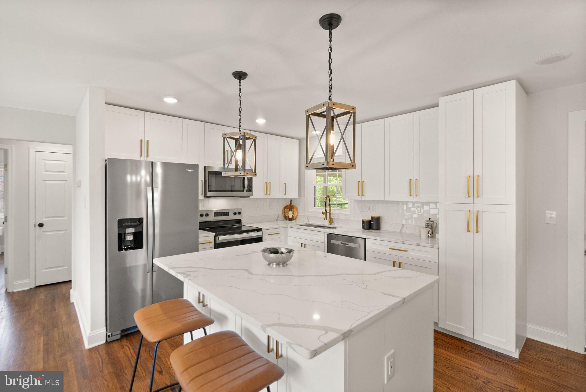 4010 Mapleton Drive Chantilly, VA 20151 - Photo 3 of 33 a kitchen with stainless steel appliances kitchen island granite countertop a sink a refrigerator and a stove