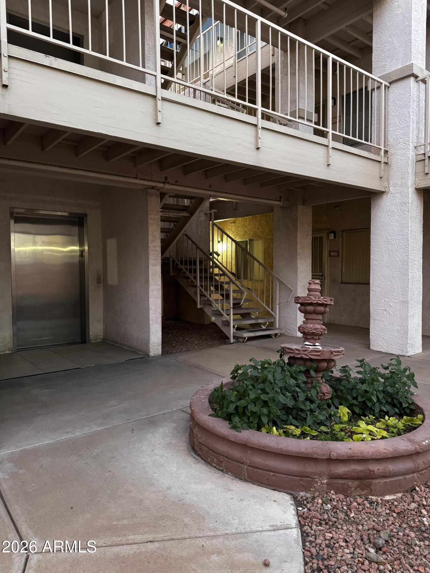 12123 West Bell Road, Unit 258 Surprise, AZ 85378 - Photo 26 of 30 a front view of a house with a yard