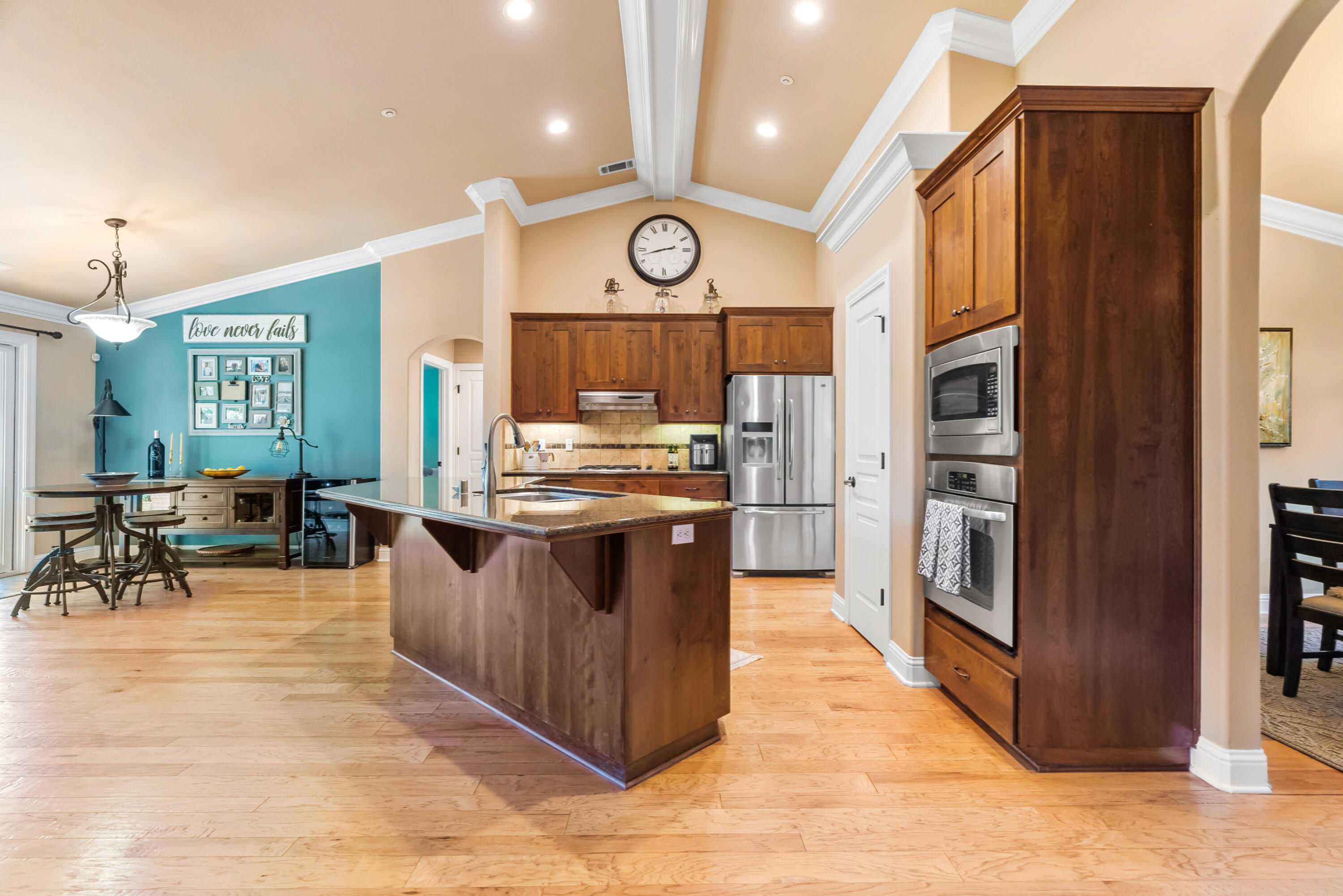 3149 Laver Street Redding, CA 96002 - Photo 11 of 40 a kitchen with stainless steel appliances granite countertop a stove a sink dishwasher and a refrigerator with wooden floor