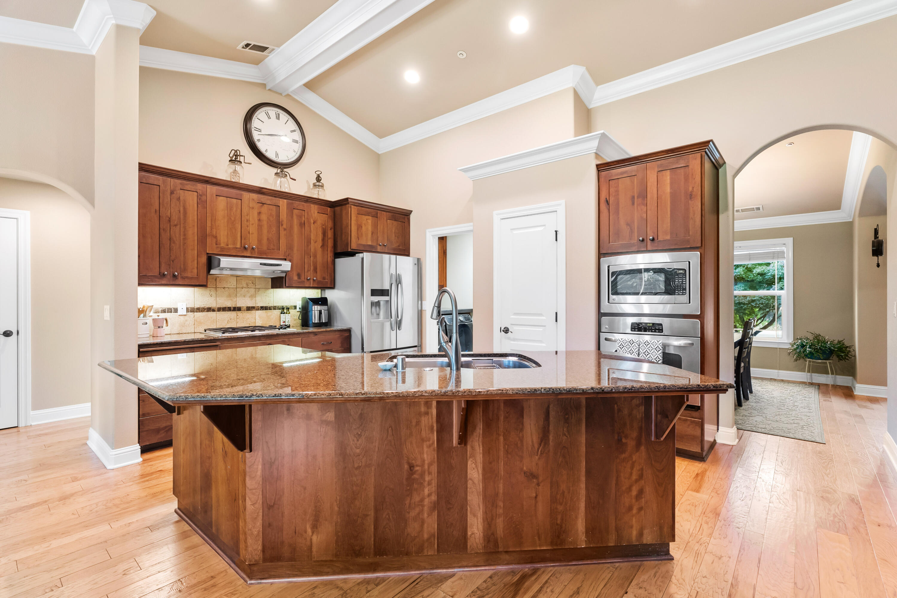 3149 Laver Street Redding, CA 96002 - Photo 12 of 40 a kitchen with kitchen island granite countertop a stove and a wooden floors