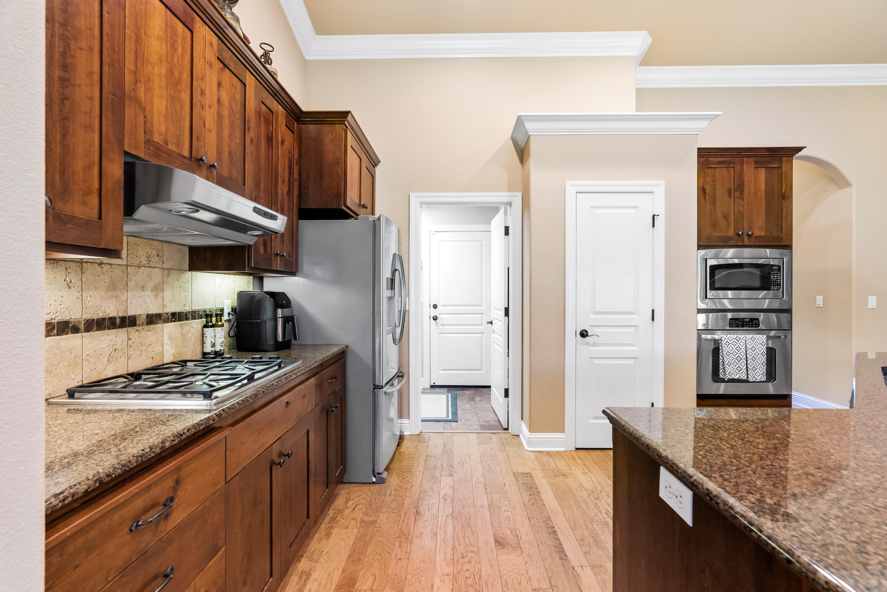 3149 Laver Street Redding, CA 96002 - Photo 14 of 40 a kitchen with stainless steel appliances granite countertop a stove a refrigerator and wooden cabinets