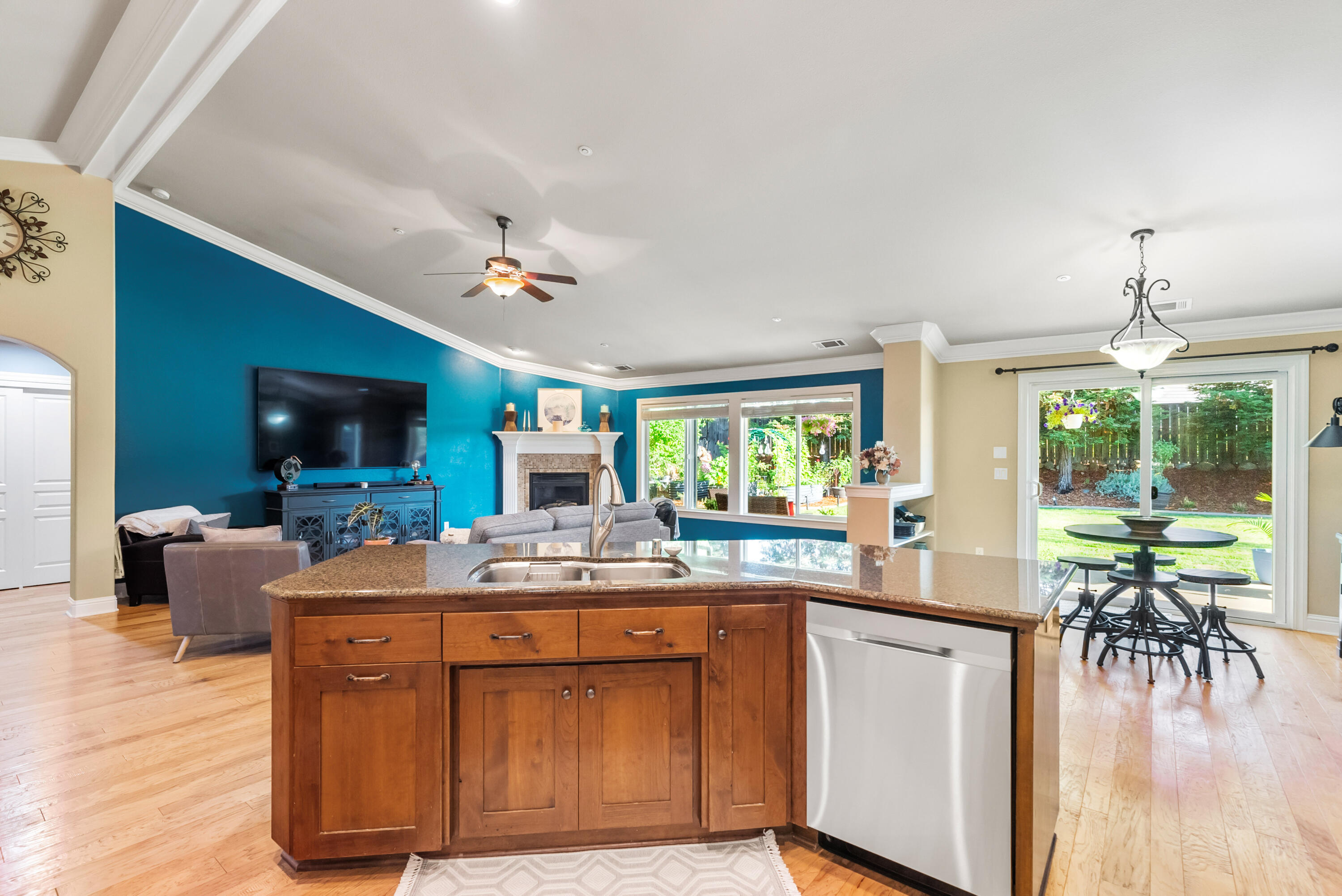 3149 Laver Street Redding, CA 96002 - Photo 15 of 40 a kitchen with a stove a sink a dining table and chairs