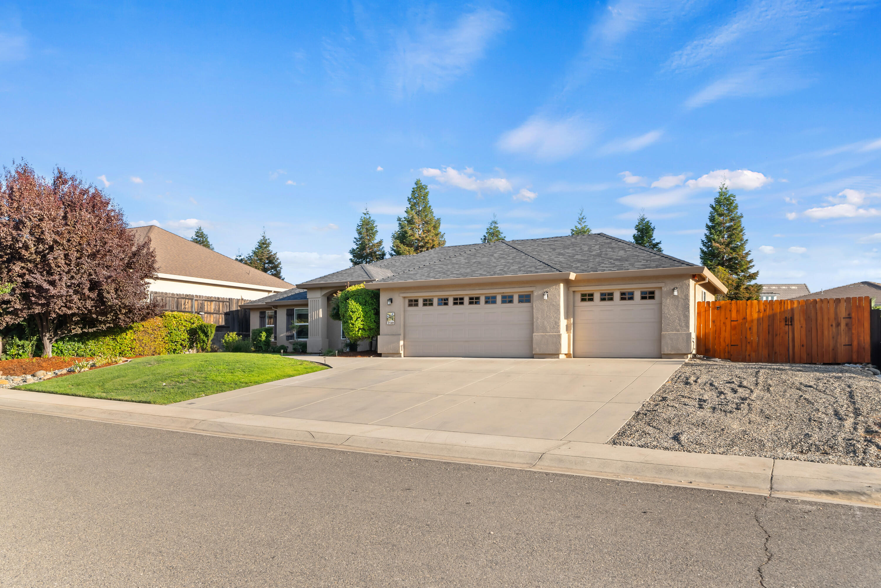 3149 Laver Street Redding, CA 96002 - Photo 2 of 40 a front view of a house with a yard and garage