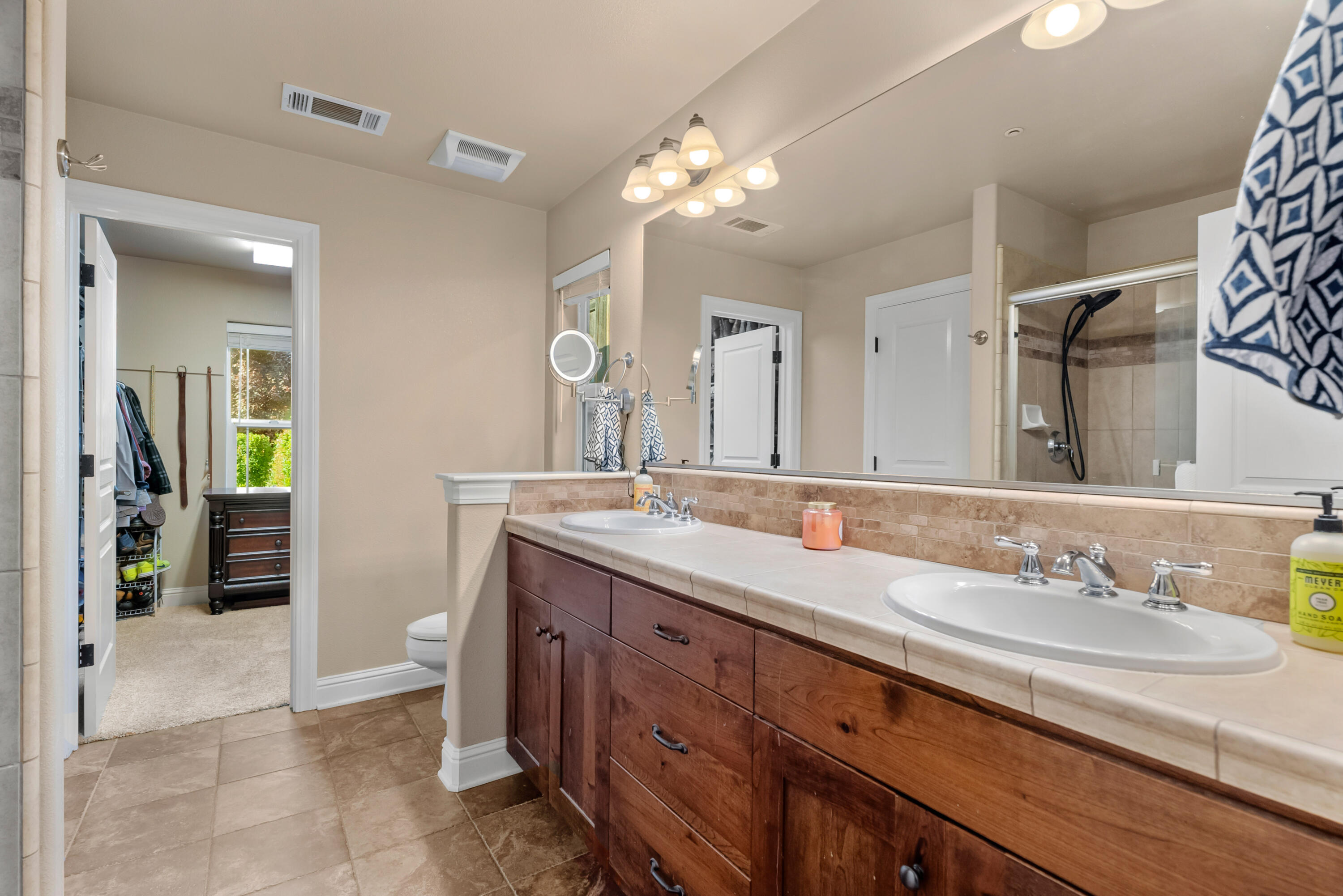 3149 Laver Street Redding, CA 96002 - Photo 22 of 40 a spacious bathroom with a granite countertop sink a toilet and a mirror