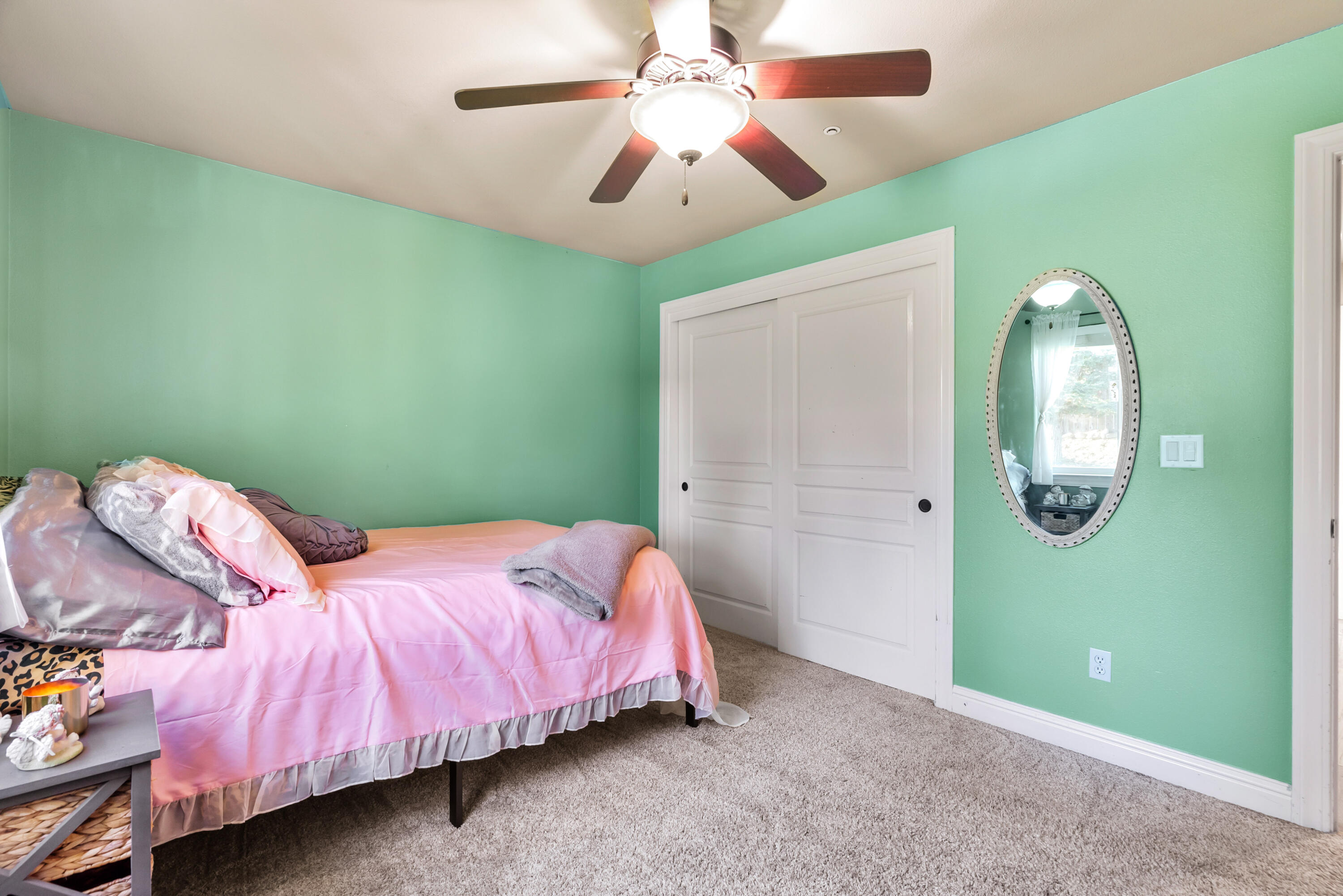 3149 Laver Street Redding, CA 96002 - Photo 26 of 40 a bedroom with a bed and a chandelier