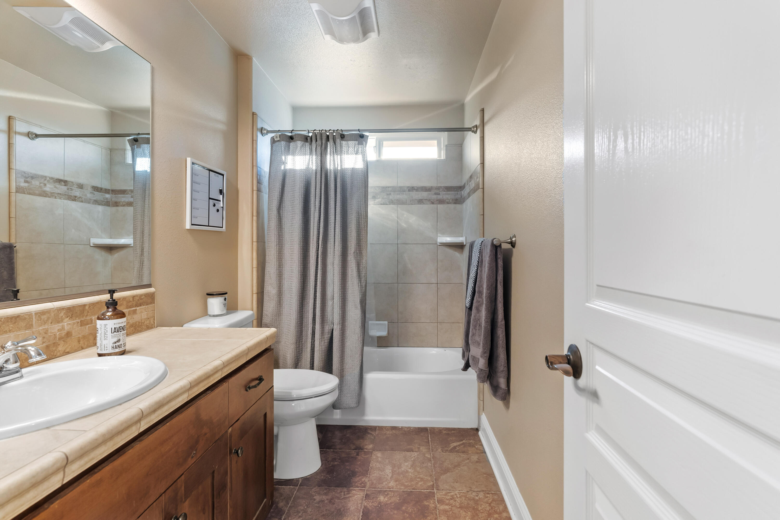3149 Laver Street Redding, CA 96002 - Photo 27 of 40 a bathroom with a double vanity sink toilet mirror and bathtub
