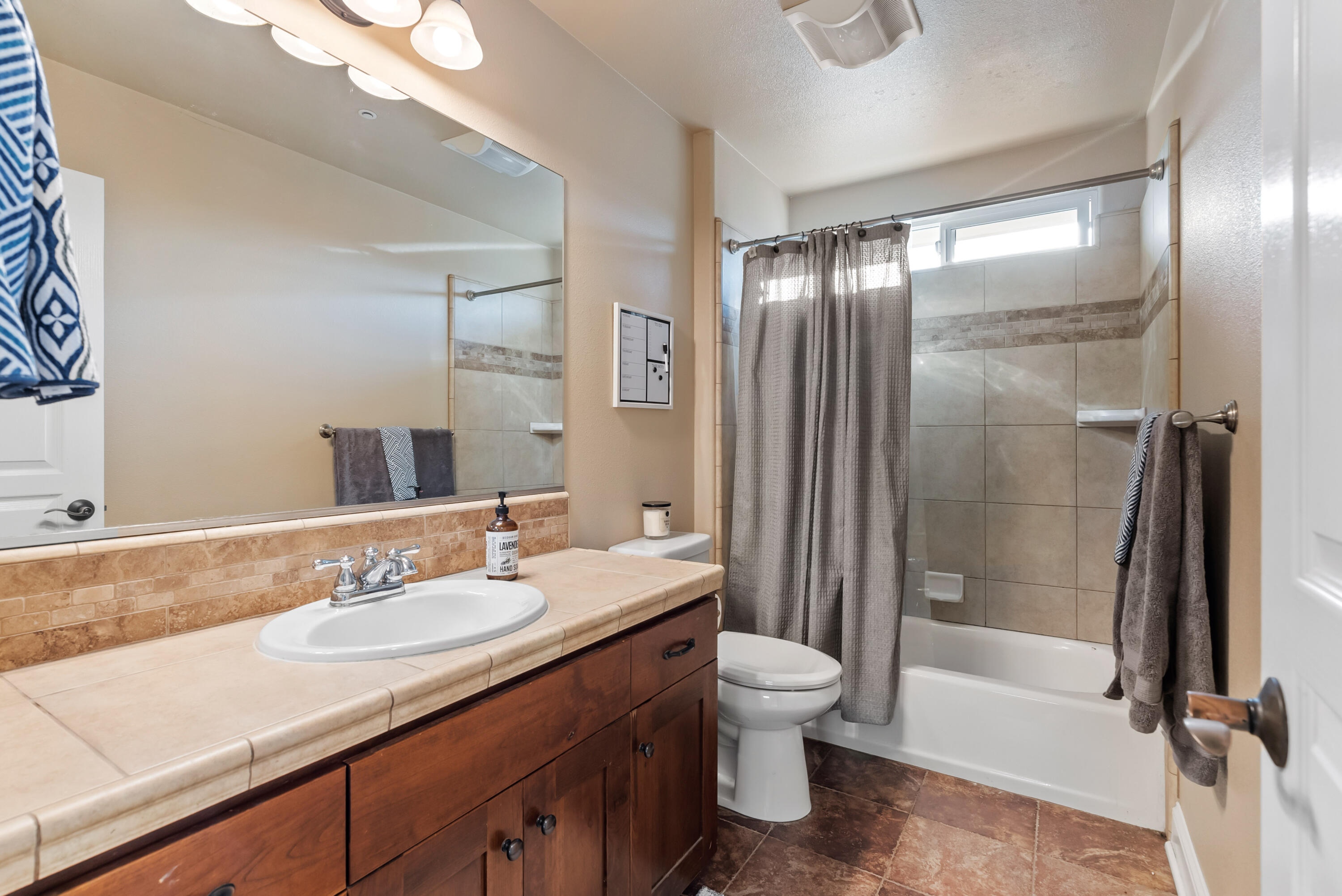 3149 Laver Street Redding, CA 96002 - Photo 28 of 40 a bathroom with a granite countertop sink toilet and shower