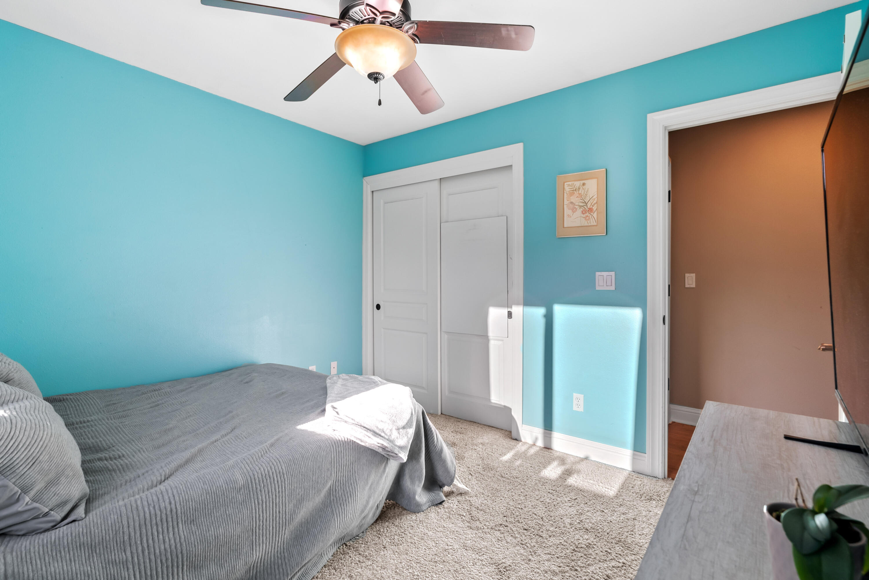 3149 Laver Street Redding, CA 96002 - Photo 30 of 40 a bedroom with a bed and a chandelier