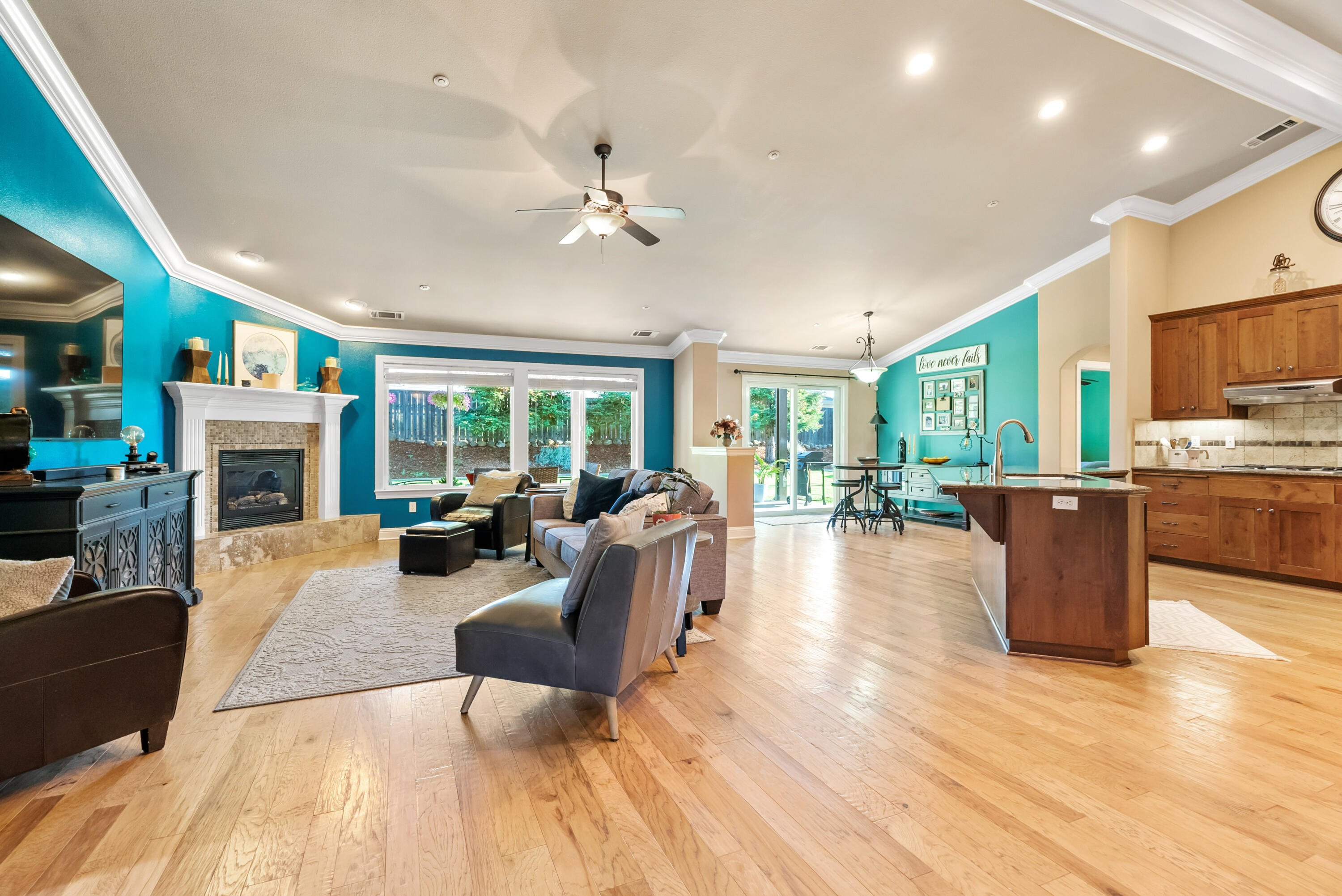 3149 Laver Street Redding, CA 96002 - Photo 6 of 40 a living room with fireplace furniture and a wooden floor