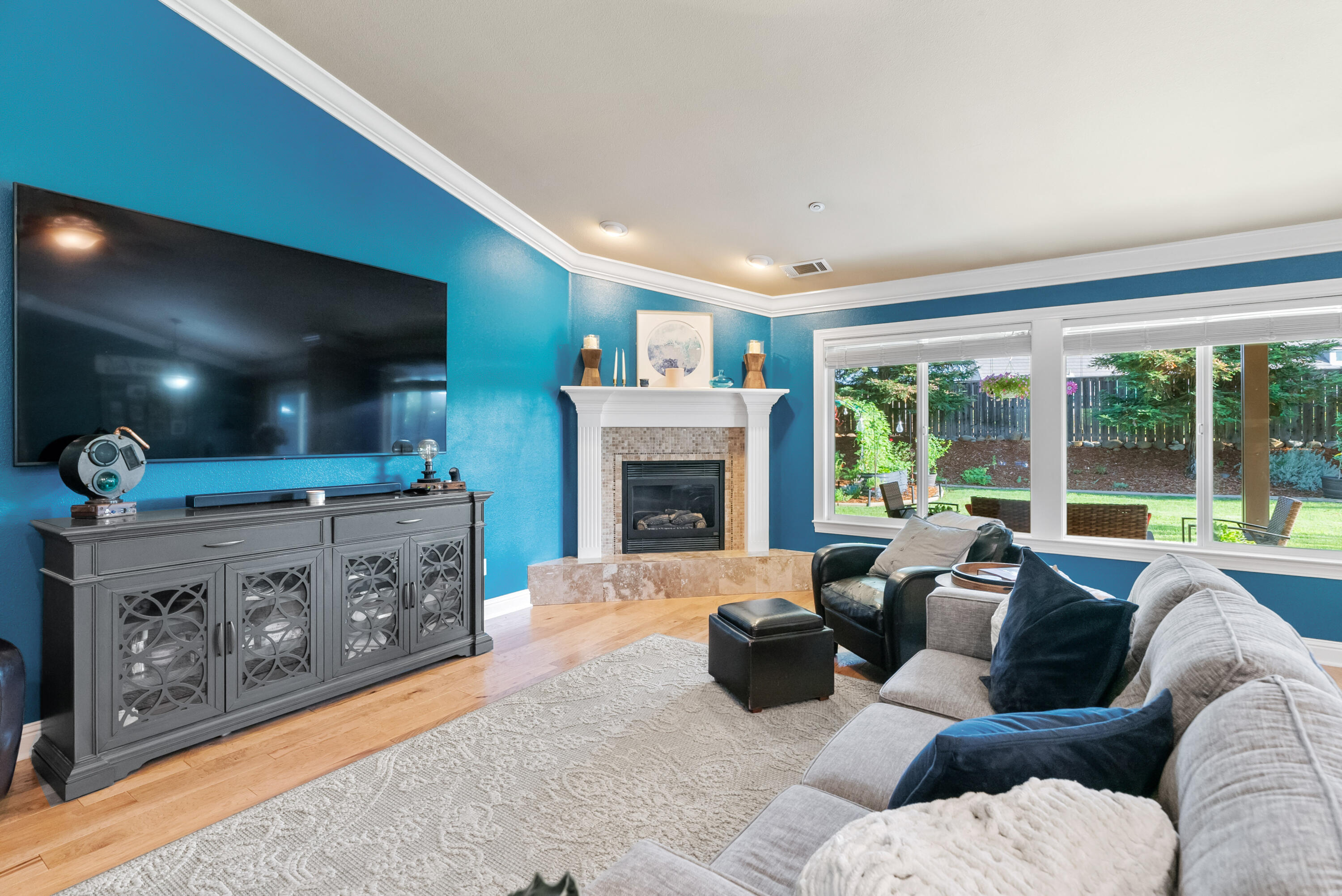 3149 Laver Street Redding, CA 96002 - Photo 7 of 40 a living room with furniture a large window and a fireplace