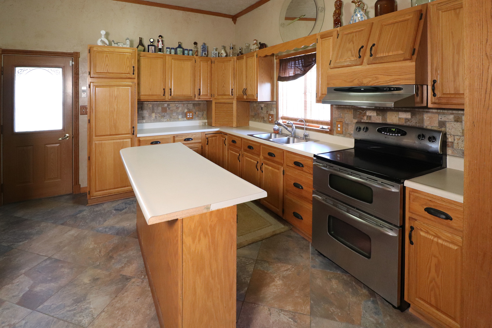 8792 Texas Church Road Clinton, IL 61727 - Photo 11 of 29 a kitchen with stainless steel appliances a stove cabinets and a refrigerator