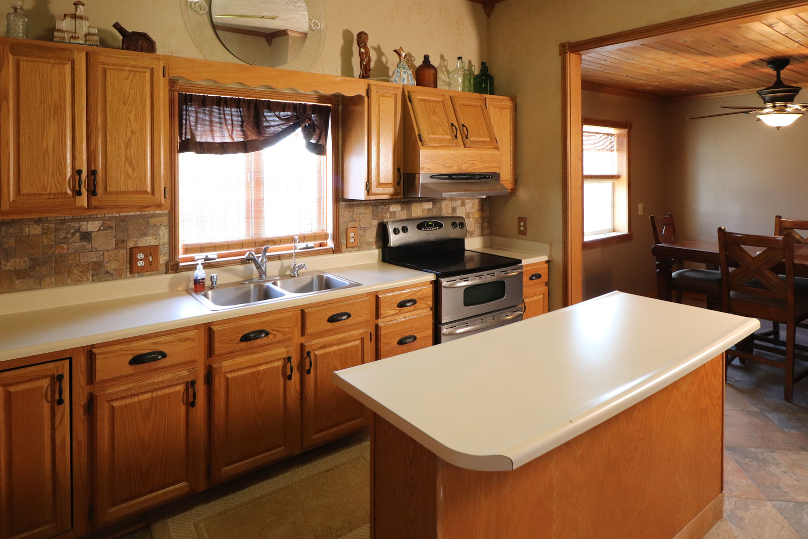 8792 Texas Church Road Clinton, IL 61727 - Photo 13 of 29 a kitchen that has a sink a stove and a table in it