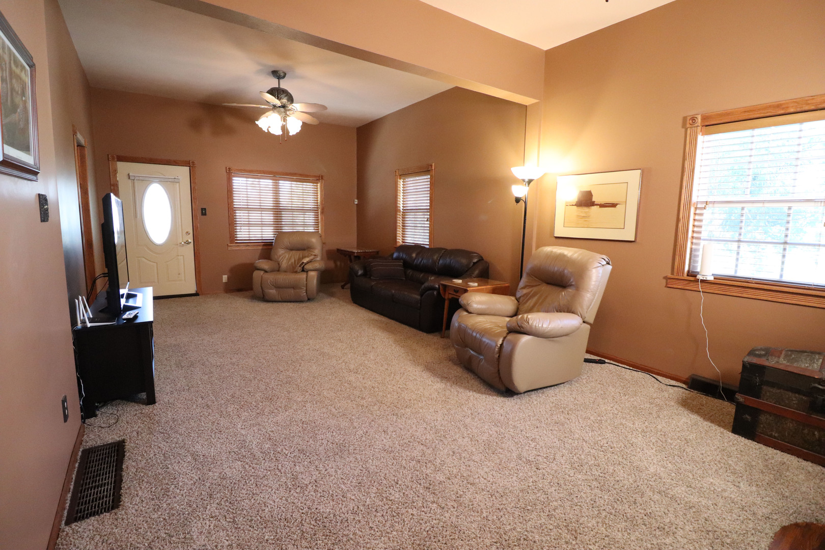 8792 Texas Church Road Clinton, IL 61727 - Photo 15 of 29 a living room with furniture and a large mirror next to a window