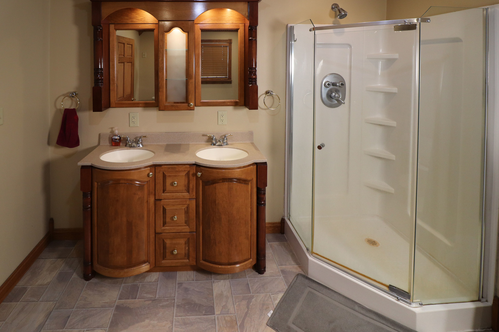 8792 Texas Church Road Clinton, IL 61727 - Photo 22 of 29 a bathroom with a sink a mirror and shower