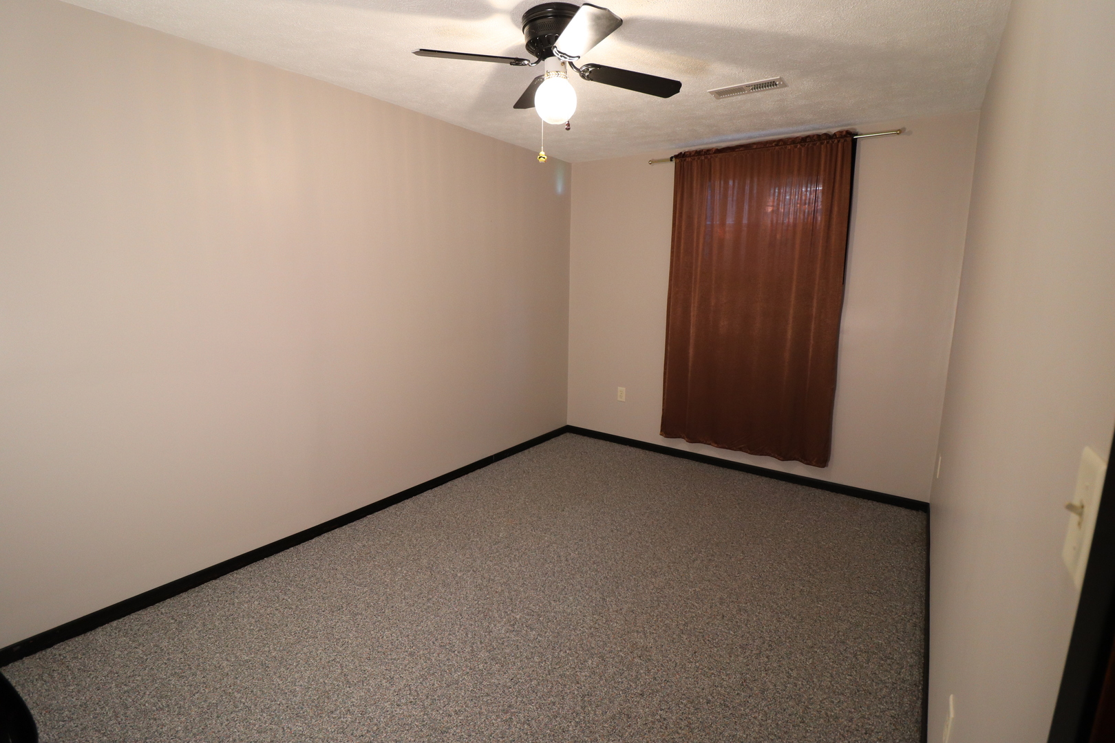 8792 Texas Church Road Clinton, IL 61727 - Photo 29 of 29 an empty room with a chandelier fan