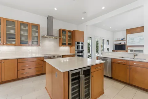 a kitchen that has a sink and a stove in it