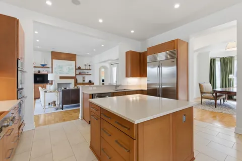 a kitchen with stainless steel appliances granite countertop a sink a stove and a refrigerator