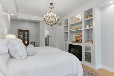 a bedroom with a bed and a chandelier