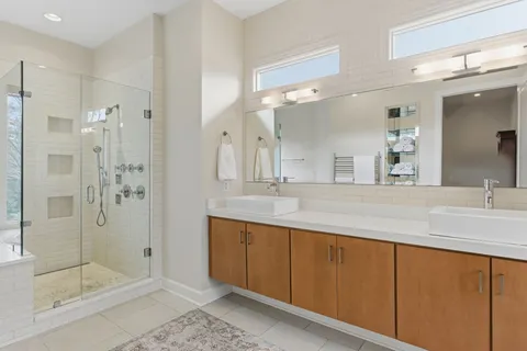 a bathroom with a shower sink and mirror