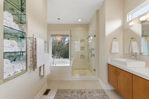a bathroom with a tub shower and sink