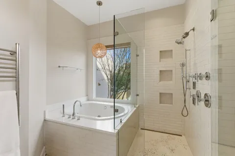 a bathroom with double vanity sink a mirror a glass door a shower and a sink