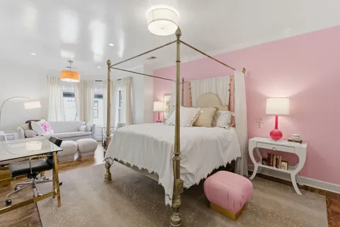 a bedroom with a bed and a chandelier