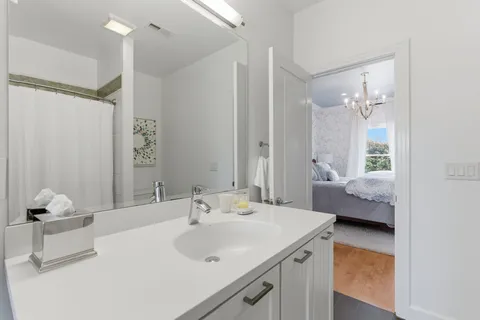 a en suite bathroom with a sink and a mirror