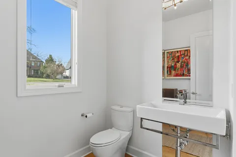 a bathroom with a sink a toilet and a mirror