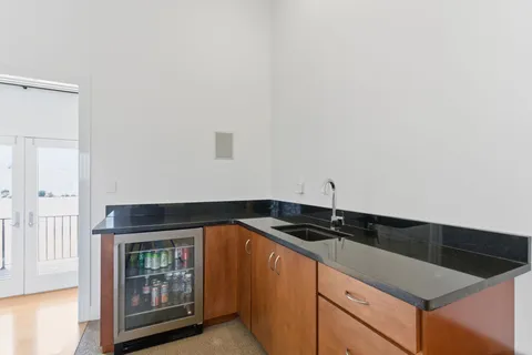 a kitchen with granite countertop a sink and cabinets