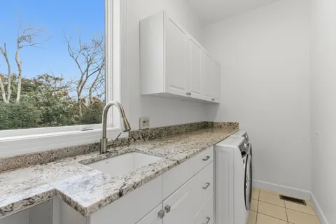 a kitchen with granite countertop a sink and a stove
