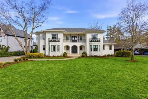 a front view of house with yard and green space