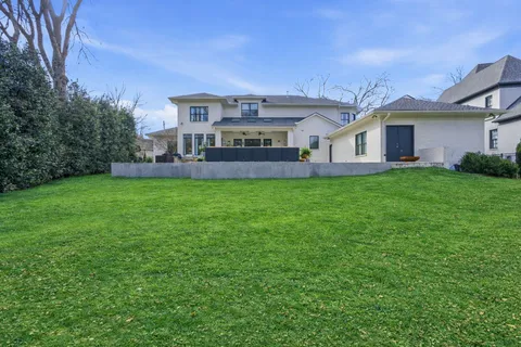 a front view of a house with a garden and yard
