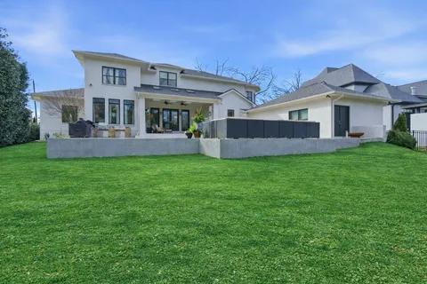 a view of a house with a yard and a porch