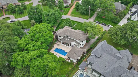 an aerial view of residential houses with outdoor and green space