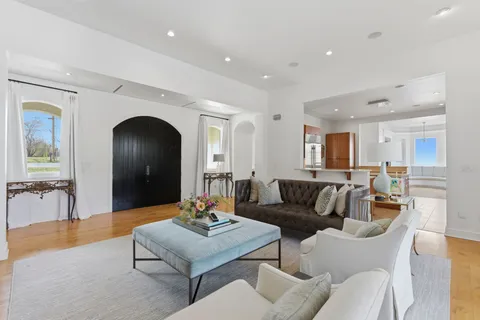 a living room with furniture and a large mirror