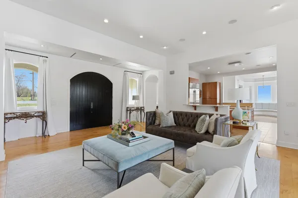 a living room with furniture and a large mirror
